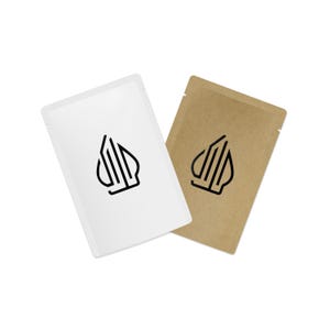 May include: Two small, rectangular pouches. One is white, the other is brown. Each pouch has a black logo of a stylized shape. The pouches are sealed at the top and are angled towards each other against a white background.