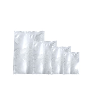 May include: Five clear plastic pouches with a white leaf pattern, arranged in a row from largest to smallest.