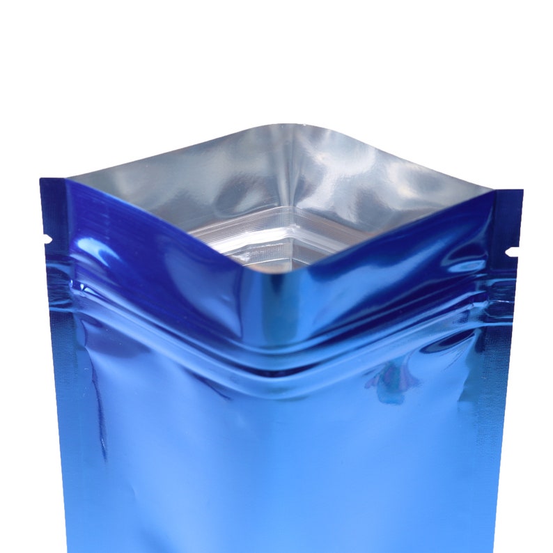 May include: A blue metallic stand-up pouch with a zipper closure. The pouch is made of a shiny, reflective material.