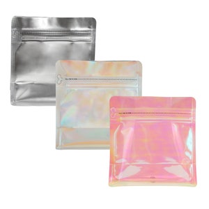 May include: Three stand-up pouches with zipper closures. The pouches are made of a clear, iridescent material. The pouch on the left is silver, the middle pouch is iridescent white, and the pouch on the right is iridescent pink.
