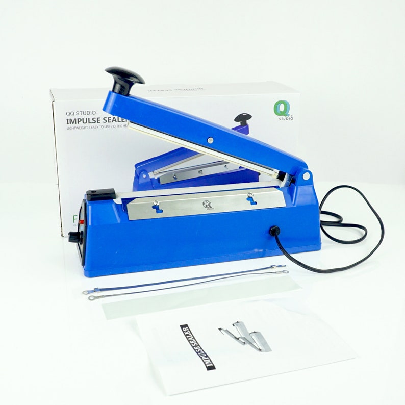 May include: Blue electric impulse sealer with a black cord and a white instruction manual. The sealer has a silver metal blade and a red power button. The manual has the text "Impulse Sealer" printed on it.