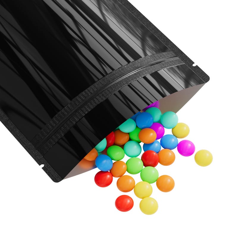 May include: A black stand-up pouch with a zipper closure, spilling out colorful candy. The pouch is made of a shiny, reflective material.