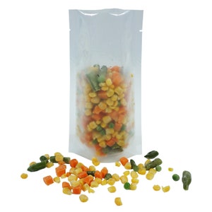 May include: A clear plastic stand-up pouch filled with frozen mixed vegetables, including corn, peas, and carrots. Some vegetables have spilled out of the pouch onto a white surface.