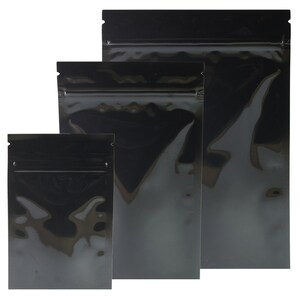 May include: Three black zippered pouches of different sizes. The pouches are made of a shiny, metallic material.