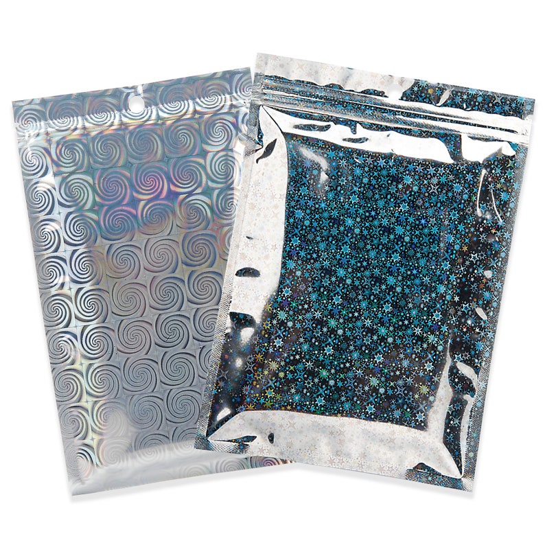 May include: Two holographic zip-top bags. One bag features a silver swirl pattern, while the other has a blue and silver starburst design. Both bags have a clear top section and a small hole near the top for hanging.