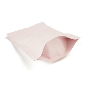 May include: A pink stand-up pouch with a zipper closure. The pouch is empty and folded in half.