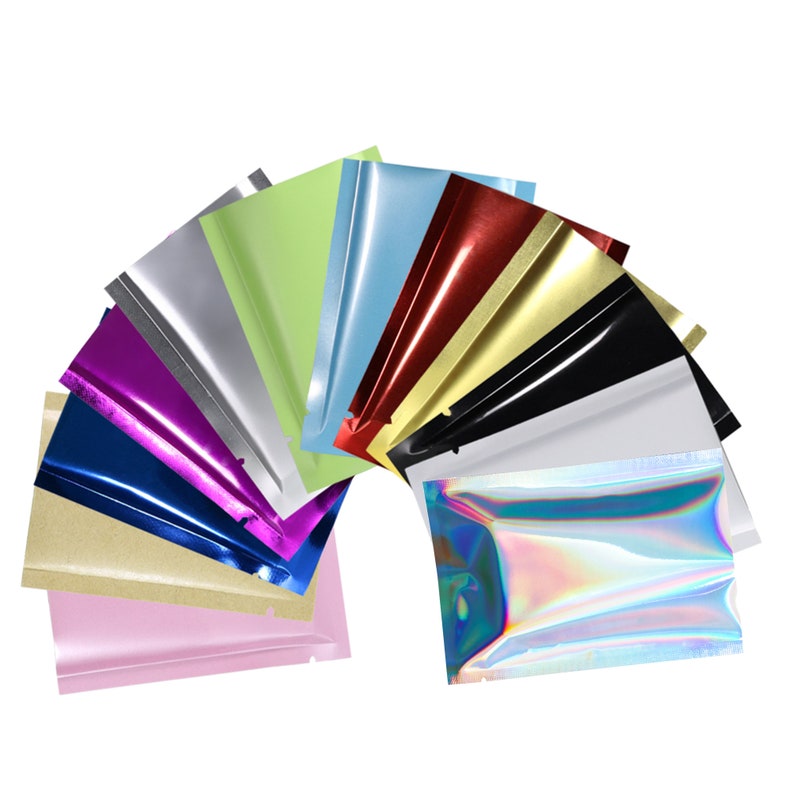 May include: Assortment of 12 different colored stand-up pouches with a zipper closure. The pouches are made of a shiny, metallic material. The colors include silver, green, blue, red, gold, black, white, purple, dark blue, brown, pink, and iridescent.