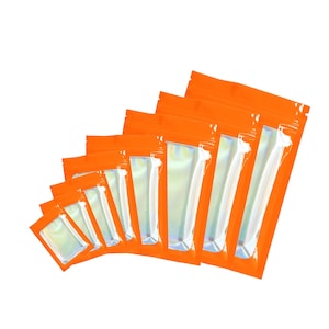 May include: A set of ten orange resealable plastic bags with iridescent clear windows. The bags are arranged in a graduated size order, with the largest bag at the top and the smallest bag at the bottom.
