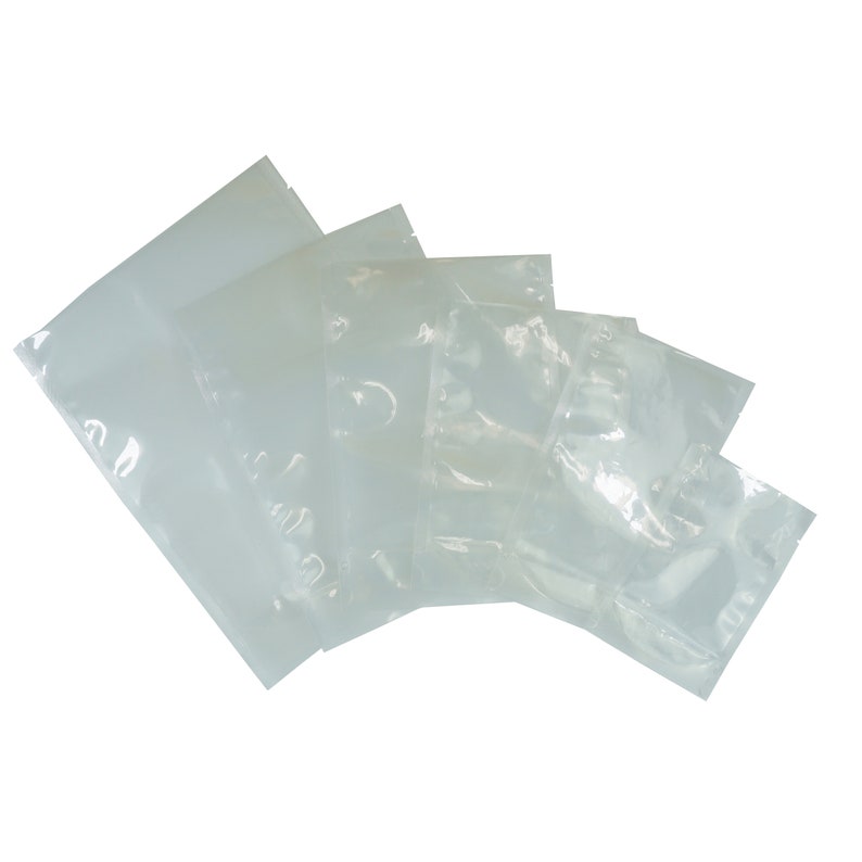 May include: A set of five clear plastic vacuum seal bags of various sizes.