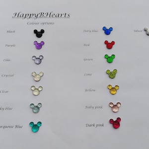 May include: A chart showing 14 different colors of glitter mouse ears. The colors are: black, purple, lilac, crystal, clear, sky blue, turquoise blue, dory blue, red, green, lime, yellow, baby pink, and dark pink.