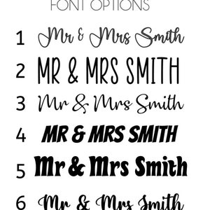 May include: A white background displays six font options for the names "Mr & Mrs Smith". The text is in black, with varying styles including cursive, bold, and all caps. The words "FONT OPTIONS" are at the top.