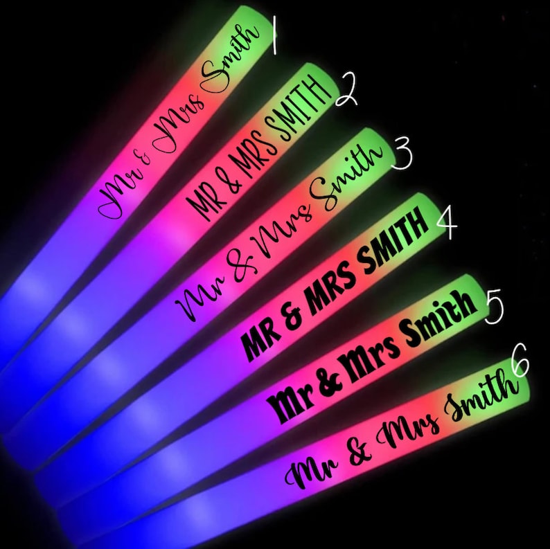 May include: Six glowing LED foam sticks with the text "Mr & Mrs Smith" and "MR & MRS SMITH" in various fonts. The sticks transition from blue to pink to green, ideal for parties and celebrations.