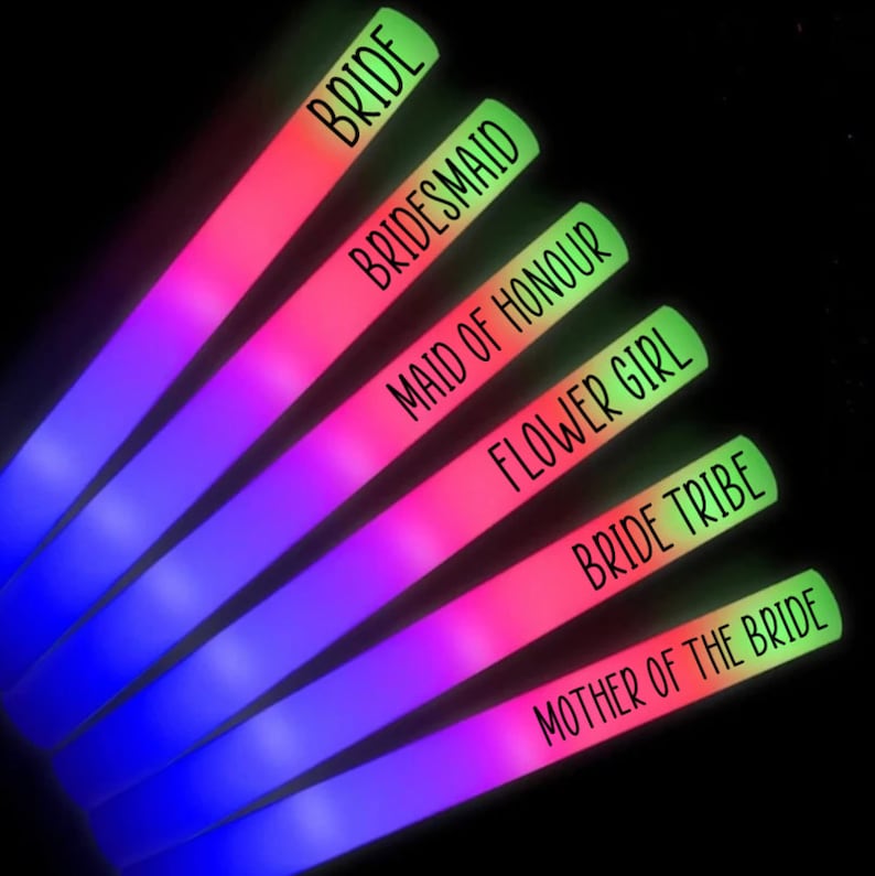 May include: Six glowing neon light sticks in a row, each with a different color gradient and text. The text on the sticks reads: BRIDE, BRIDESMAID, MAID OF HONOUR, FLOWER GIRL, BRIDE TRIBE, and MOTHER OF THE BRIDE.