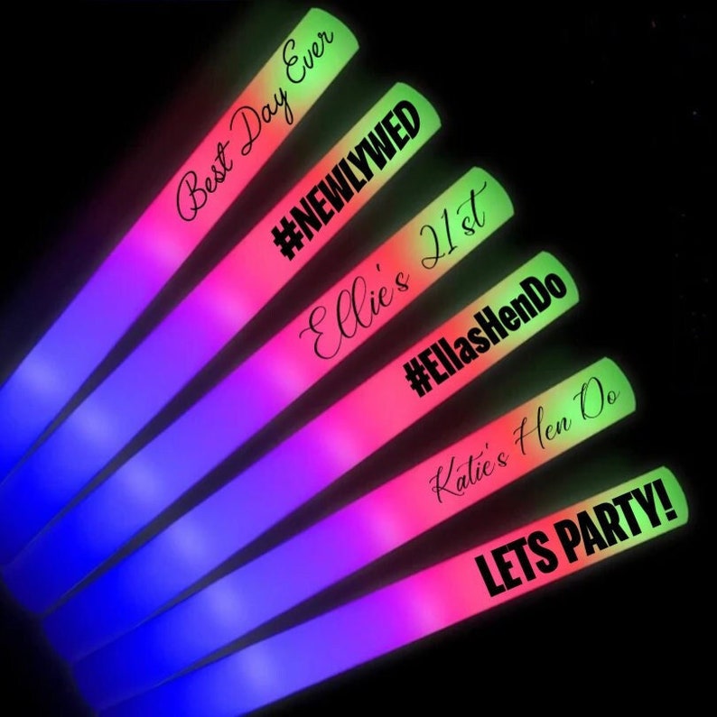 May include: A collection of colorful LED foam glow sticks. Each stick transitions from blue to pink to green. Text on the sticks includes "Best Day Ever," "#NEWLYWED," "Ellie's 21st," "#EllasHenDo," "Katie's Hen Do," and "LETS PARTY!"