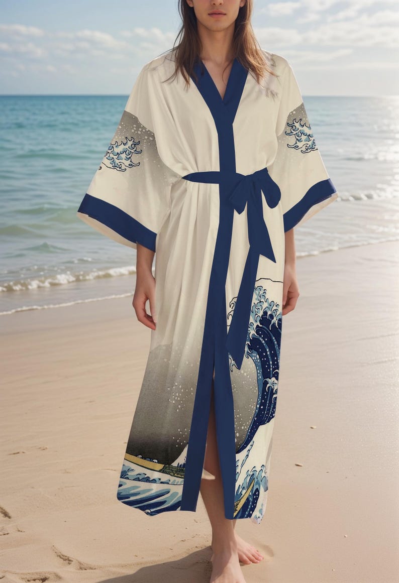 May include: A white silk robe with a blue and gray print of a wave. The robe has a black sash and a V-neck.