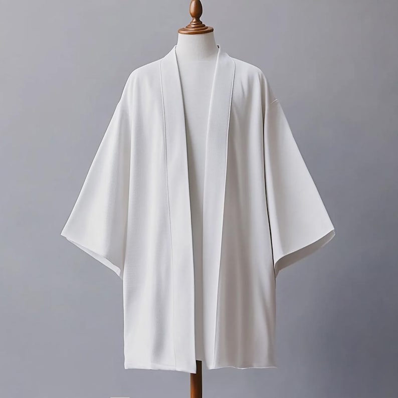 May include: A white lightweight kimono with a simple design. The kimono has long sleeves and a wide, open front.