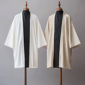 May include: Two long-sleeved robes, one white and one beige, with black fabric underneath. Both robes have a traditional Japanese style.