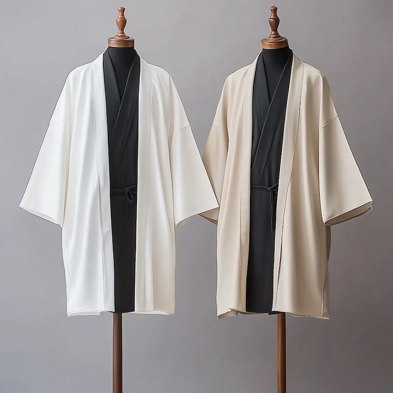 May include: Two long-sleeved robes, one white and one beige, with black fabric underneath. Both robes have a traditional Japanese style.