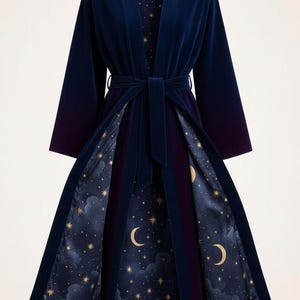 May include: A long, dark blue velvet robe with a matching belt. The interior lining features a celestial design of gold stars, crescent moons, and clouds on a navy background. The robe has long sleeves and a shawl collar.