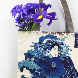 May include: A tote bag with a floral design and a Japanese print of a woman in a blue and white kimono. The text on the bag reads "寿" in Japanese.