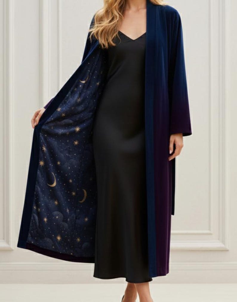 May include: A long, open-front robe in navy blue, with a purple trim and a celestial-themed lining. The lining features a dark blue background with gold stars and crescent moons. The robe is made of a soft, flowing fabric.