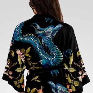 May include: Black silk robe with an embroidered blue dragon and floral design.
