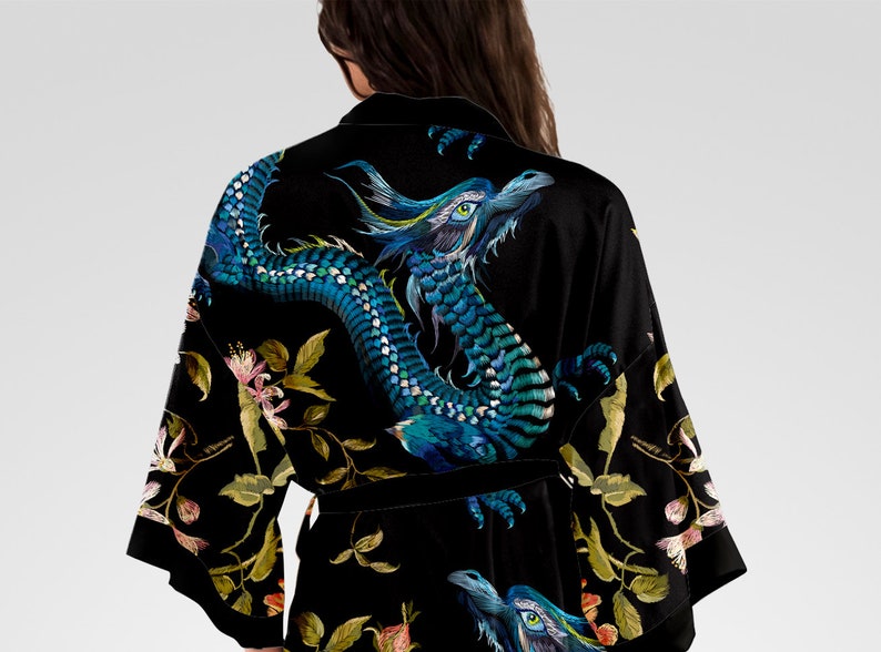 May include: Black silk robe with an embroidered blue dragon and floral design.