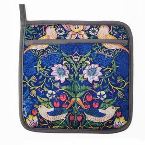 May include: A blue and green pot holder with a floral and bird pattern. The pot holder has a gray border and a loop for hanging.