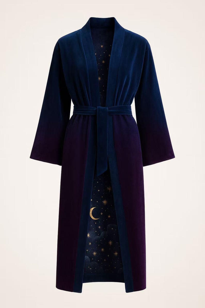 May include: A long, velvet robe in navy blue and deep purple, with a matching belt. The interior lining features a celestial design of a crescent moon and stars on a dark blue background. The robe has wide sleeves.