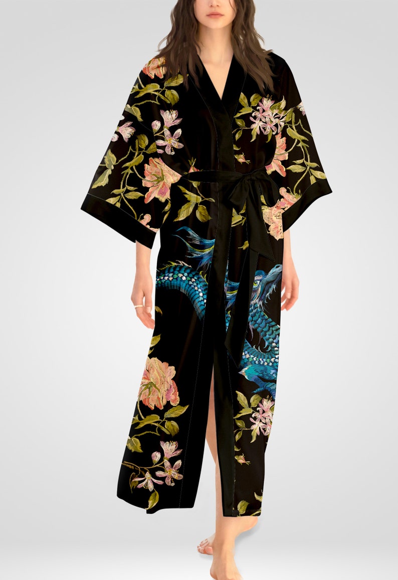 May include: Black silk robe with a floral and dragon print. The robe has a long, flowing silhouette and a tie belt.