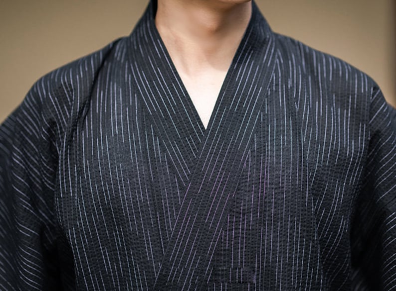 May include: A black and white striped kimono with a V-neck collar.