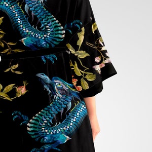 May include: Black silk robe with a blue and green dragon print. The robe has a velvet sash and floral embroidery.