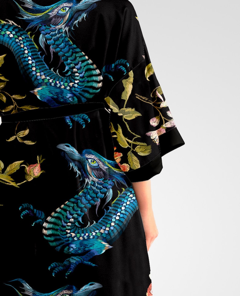 May include: Black silk robe with a blue and green dragon print. The robe has a velvet sash and floral embroidery.