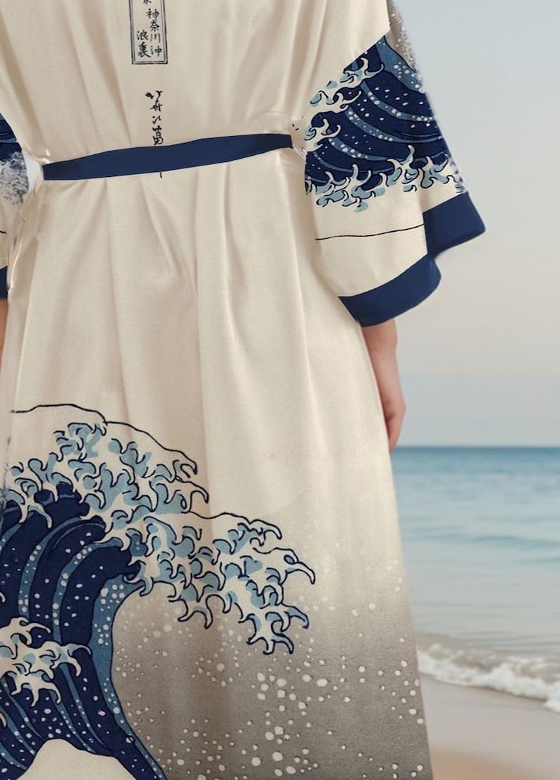 May include: A white robe with a blue and white wave design. The robe has a blue sash and the text "神奈川沖浪裏" is printed on the back.