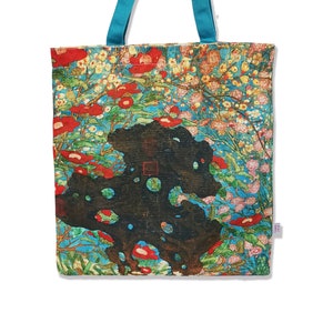 May include: A turquoise tote bag with a floral print featuring red, pink, and white flowers on a blue background. The bag has a black and brown design in the center.