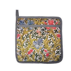 May include: A gray and white pot holder with a floral pattern. The pattern features yellow, green, blue, and red flowers and leaves.