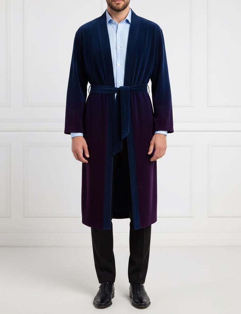 May include: A long, two-tone robe in navy blue and deep purple, with a matching belt. The robe has a velvet texture and is worn over a light blue dress shirt and black pants. The robe's design features a navy blue trim.