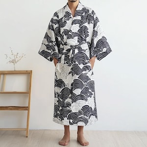 May include: A black and white patterned robe with a wave design. The robe has a sash that ties at the waist.