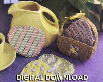 May include: A digital download pattern for crocheted pastel Easter egg coasters. The pattern includes a basket and four coasters, two with stripes and two with a checkered pattern.
