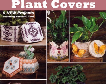 May include: A magazine cover featuring various plastic canvas plant cover patterns. The designs include geometric patterns, floral motifs, and a house-shaped cover. The text reads "Plastic Canvas Pattern Plant Covers" and "6 NEW Projects".