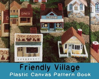May include: A book of plastic canvas patterns for creating a friendly village. The cover features colorful miniature models of a school, church, diner, dry goods store, antiques shop, and a house.