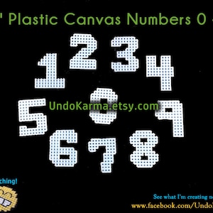 May include: White plastic canvas numbers 0-9, each measuring 2 inches. The numbers are arranged in a circle on a black background. The text "UndoKarma.etsy.com" is visible in the center of the circle.