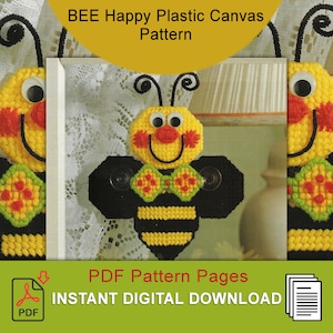 May include: A PDF pattern for a plastic canvas craft project featuring a smiling bee with black and yellow stripes, red cheeks, and a green bow tie. The bee is holding two suction cups. The pattern is for instant digital download.