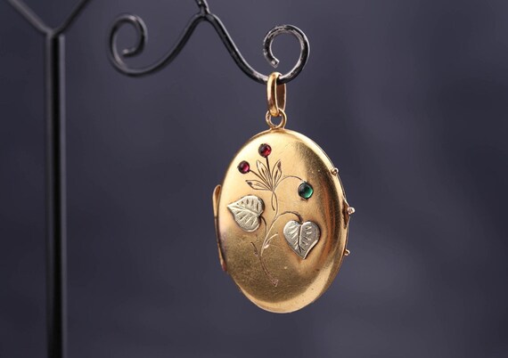 Antique golden locket. Green and red cabochons. Go