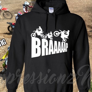 May include: Black hooded sweatshirt with a white graphic of motocross riders and the word "BRAAAAP".