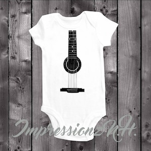 May include: White baby onesie with a black silhouette of a guitar on the front.