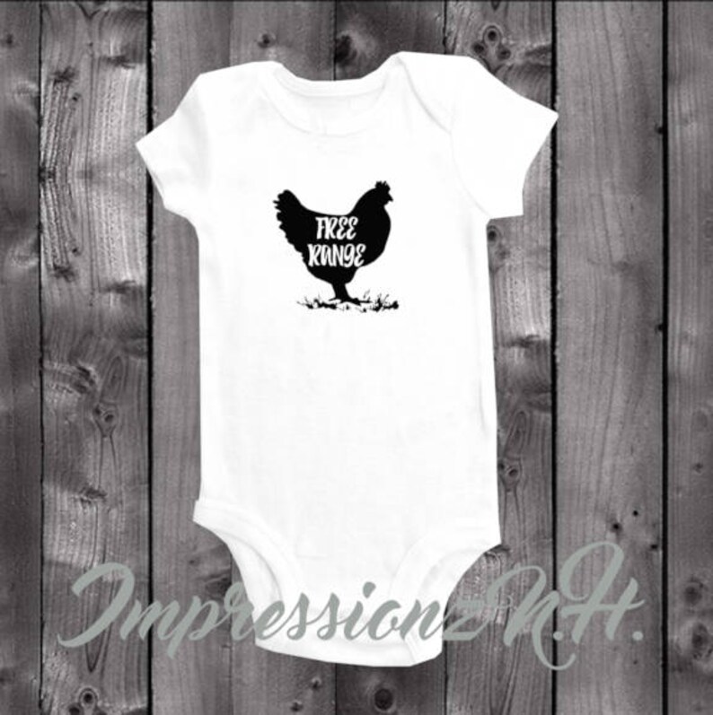 May include: White baby onesie with a black silhouette of a chicken and the text "Free Range" printed on the front.