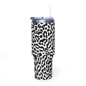 May include: A tall cylindrical tumbler featuring a black and white leopard print pattern across the entire exterior. The container includes a clear plastic lid with a matching clear straw inserted through the top center opening of the lid.