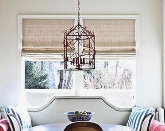 May include: A dining nook with a round wooden table and four chairs. A built-in bench with striped and pink pillows sits against the window. A decorative chandelier hangs above the table, and the room has hardwood floors.