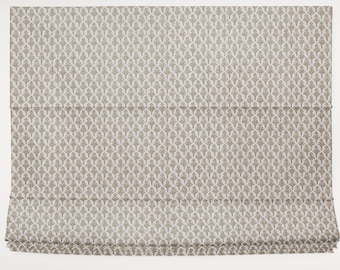 May include: A Roman shade with a repeating pattern of stylized leaves in a neutral beige color. The fabric is folded in horizontal pleats, creating a layered effect. This window treatment offers a classic and elegant design.
